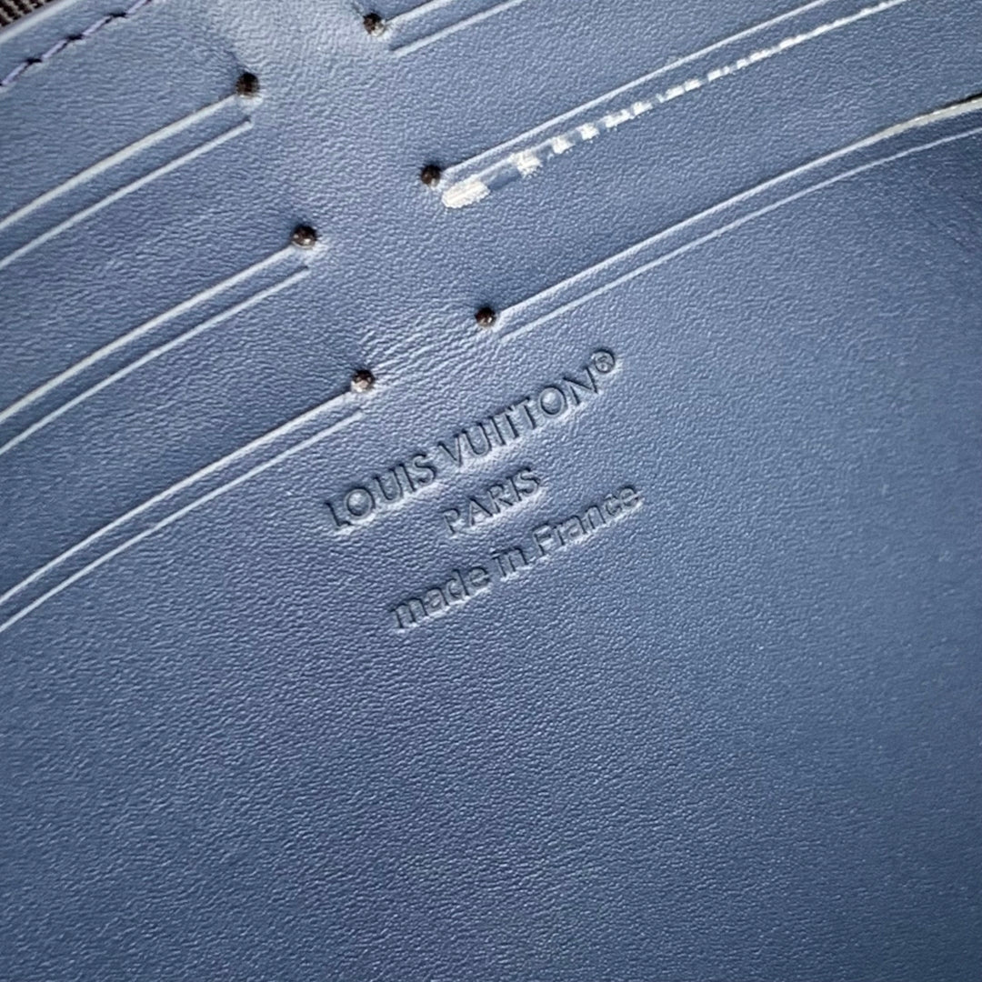 POCHETTE VOYAGE 27 IN DARK BLUE MONOGRAM ECLIPSE CALFSKIN EMBOSSED LOGO