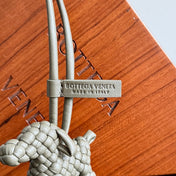 BOTTEGA VENETA 25S DOG CHARM IN GREIGE CALFSKIN