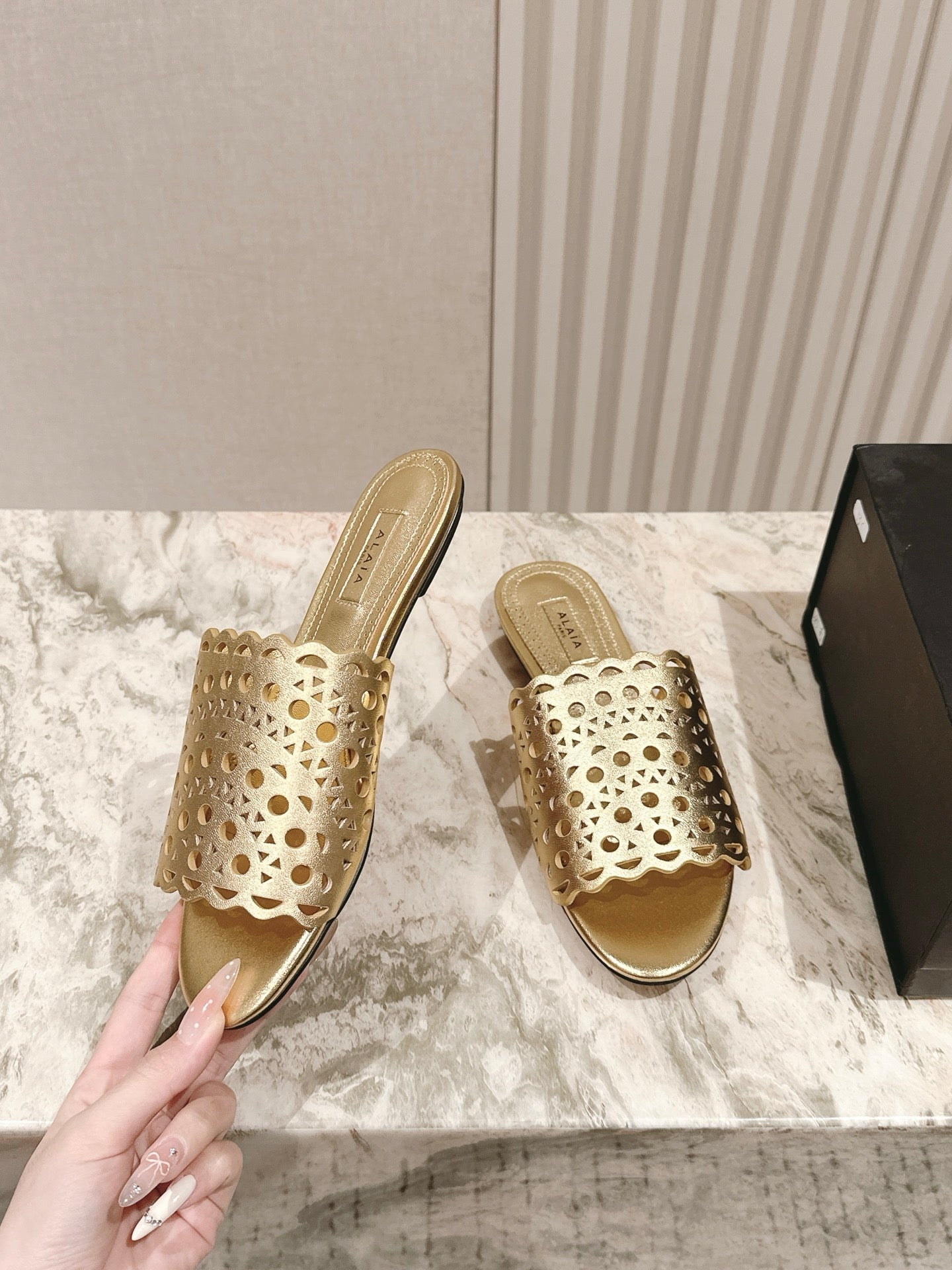 ALAIA PERFORATED SLIDE SANDALS 25S IN LIGHT GOLD LAMBSKIN
