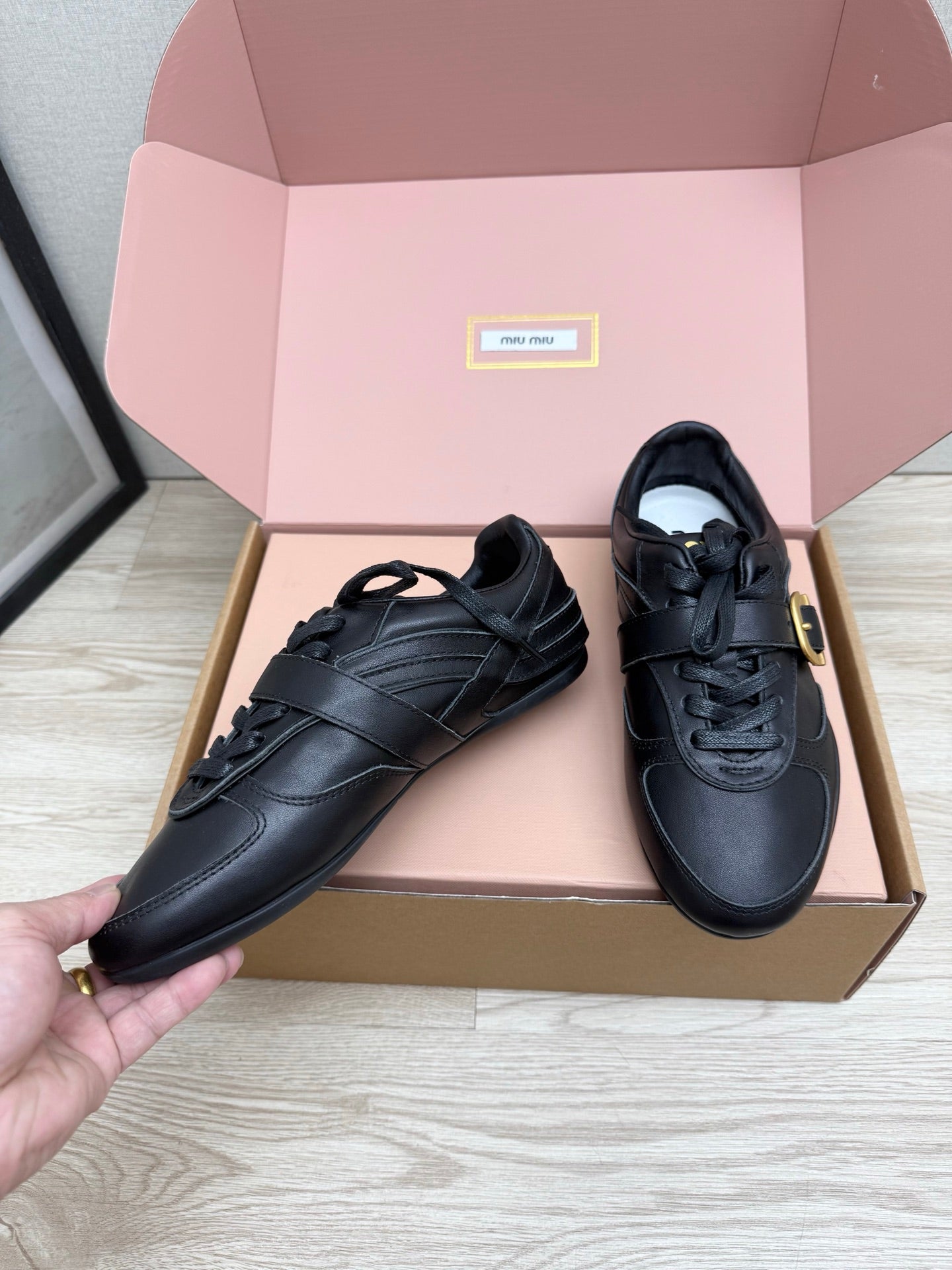 MIUMIU 26S BUCKLE SNEAKERS IN BLACK CALFSKIN WITH GOLD HARDWARE