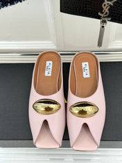 ALAIA FLAT MULE IN LIGHT PINK LAMBSKIN WITH GOLD HARDWARE