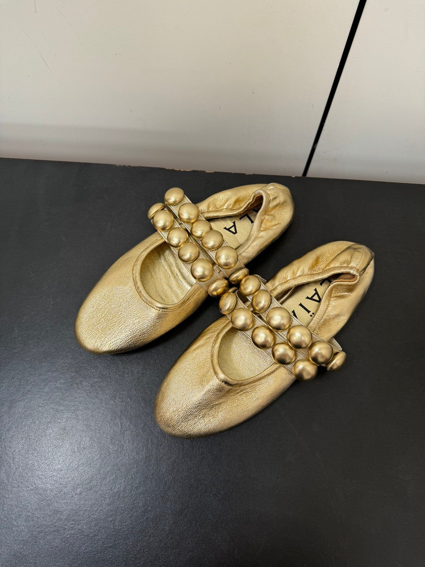 ALAIA SPHERE BALLET FLATS IN GOLDEN LAMBSKIN