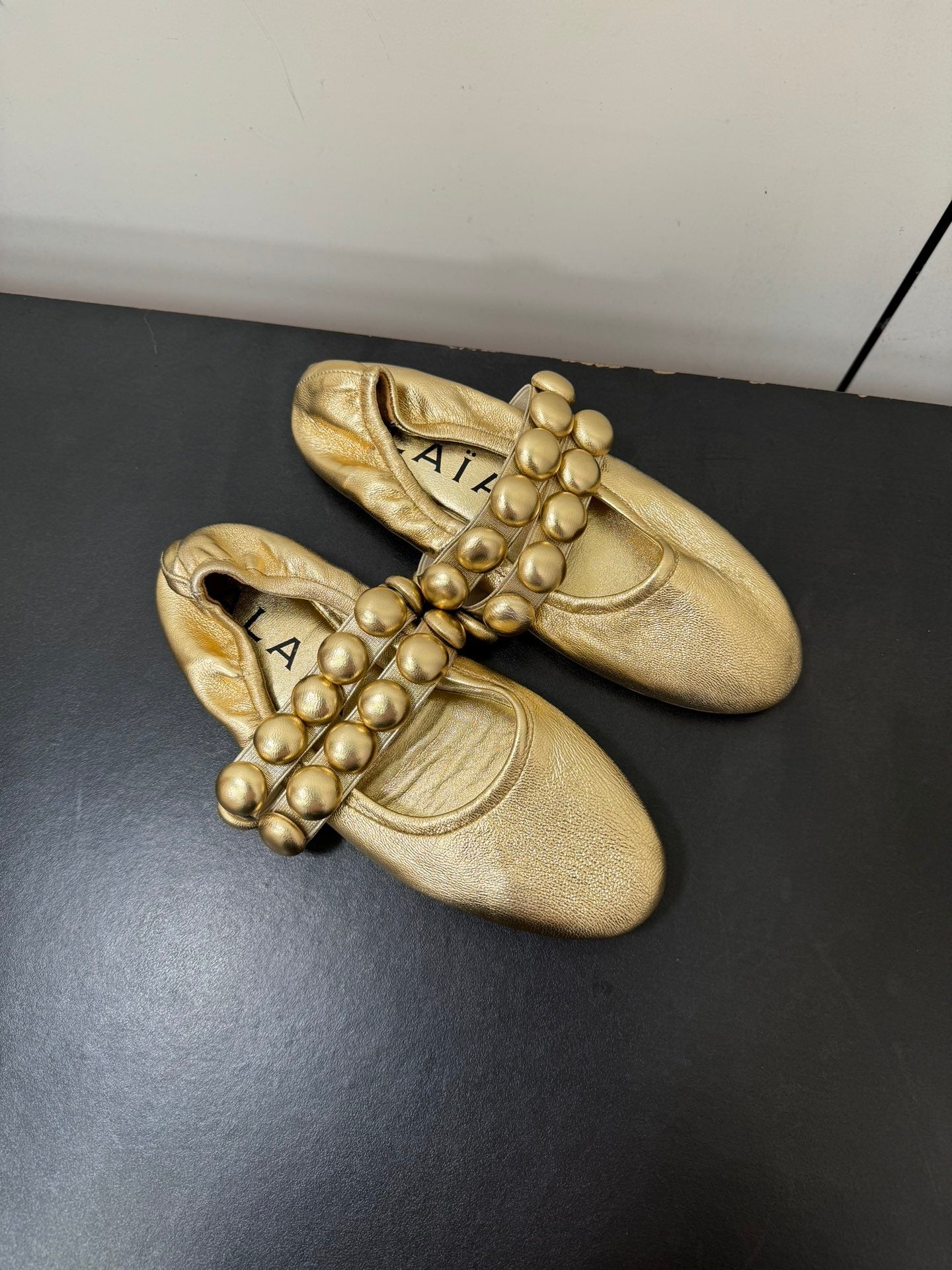 ALAIA SPHERE BALLET FLATS IN GOLDEN LAMBSKIN
