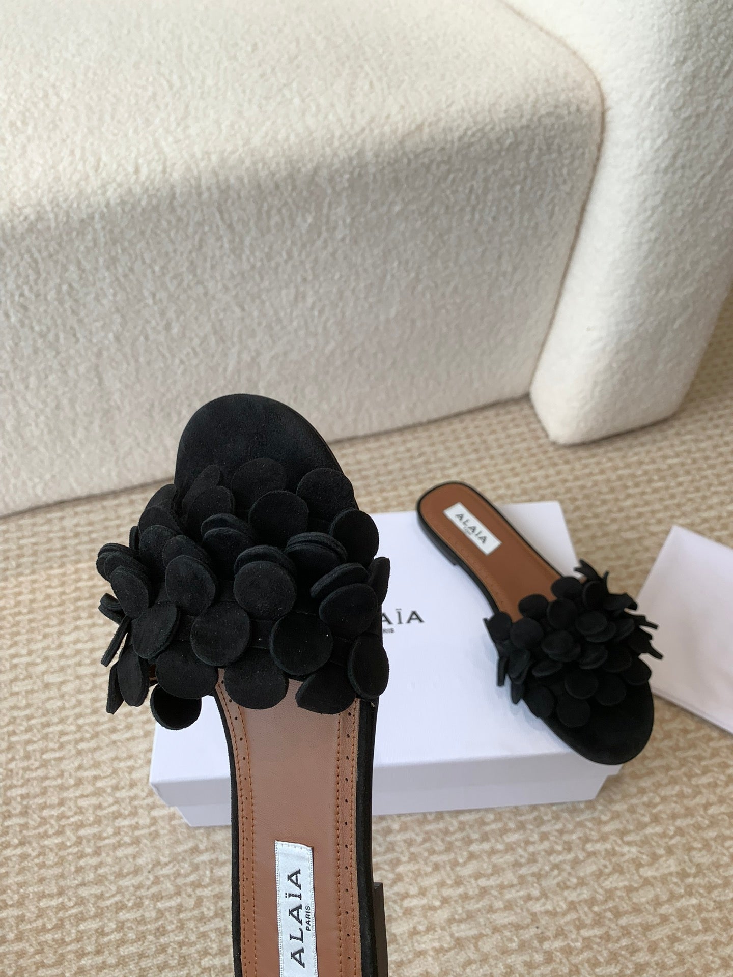 ALAIA FLAT MULE IN BLACK SUEDE