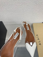 ALAIA LE COEUR FLAT SLINGBACKS IN WHITE PATENT LAMBSKIN