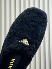 PRADA 25S CLOGS IN BLACK SHEARLING